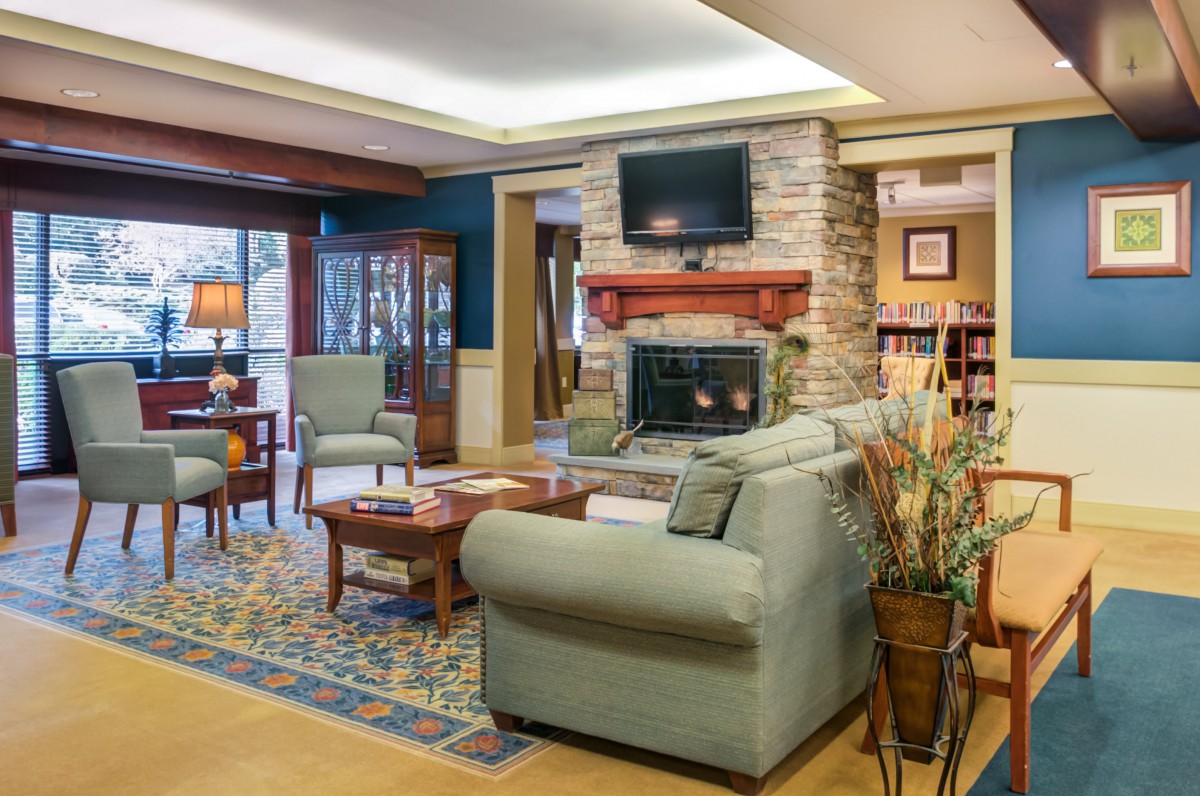 A cozy living room with a fireplace, comfortable seating, and a television.