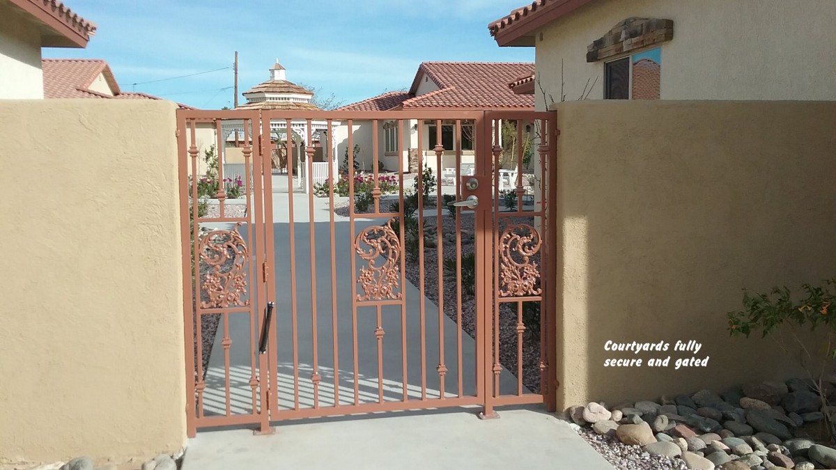 A decorative iron gate at the entrance of a residential property.