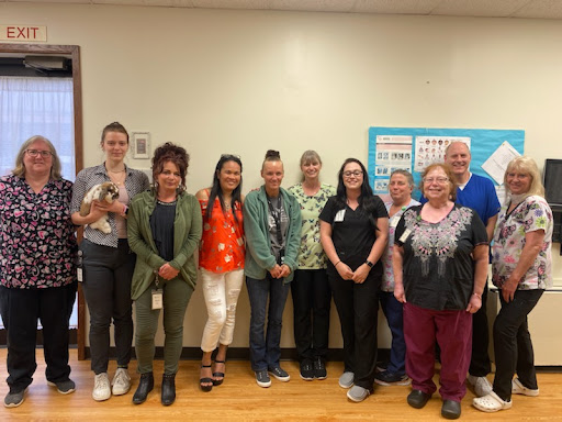 A dedicated team of healthcare professionals posing together in a warm and friendly environment.
