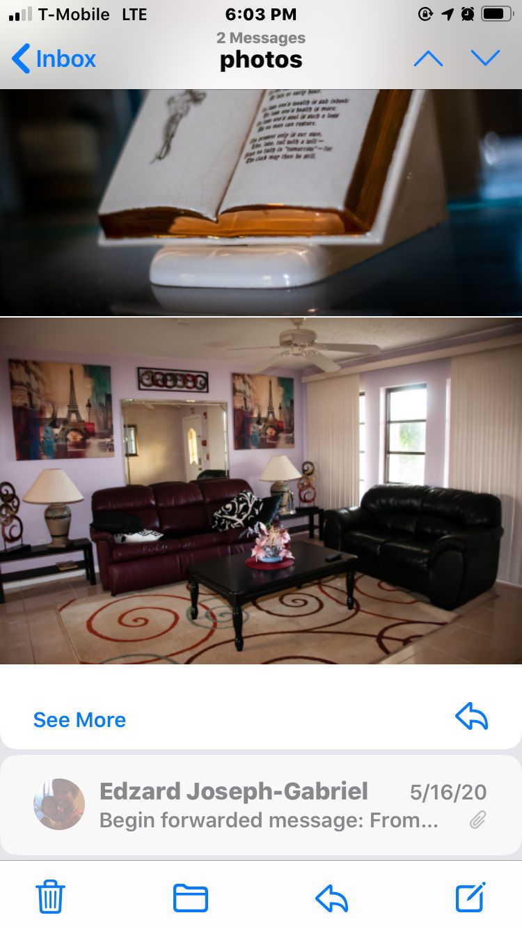 A cozy living room with leather sofas, a coffee table, decorative artwork, and lamps.