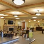 A spacious living room with modern furnishings, featuring a fireplace and a dining area.