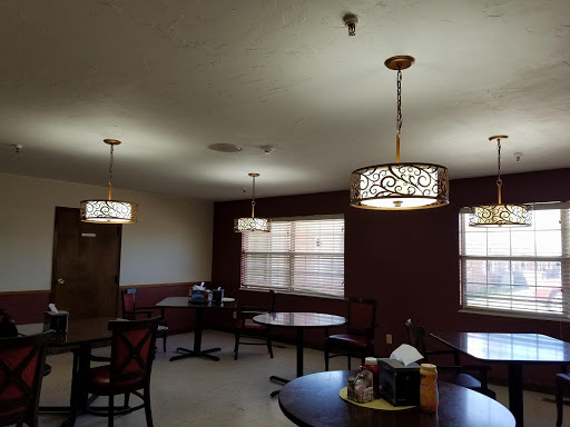 A cozy dining area featuring stylish lamps and comfortable seating.