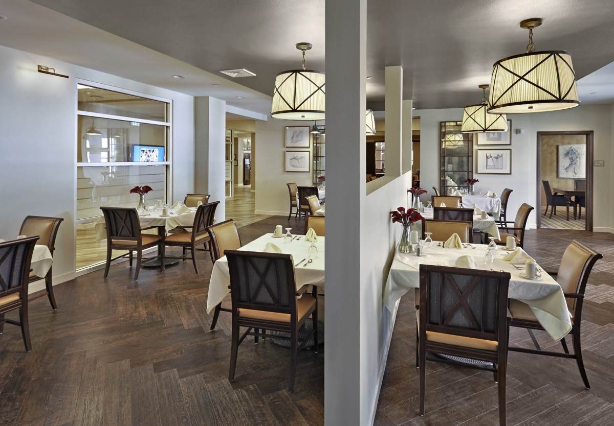 An elegant restaurant dining area with neatly arranged tables and ambient lighting.