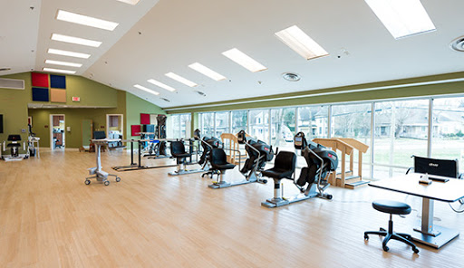 A bright and spacious gym area equipped with various exercise machines, perfect for fitness and rehabilitation.