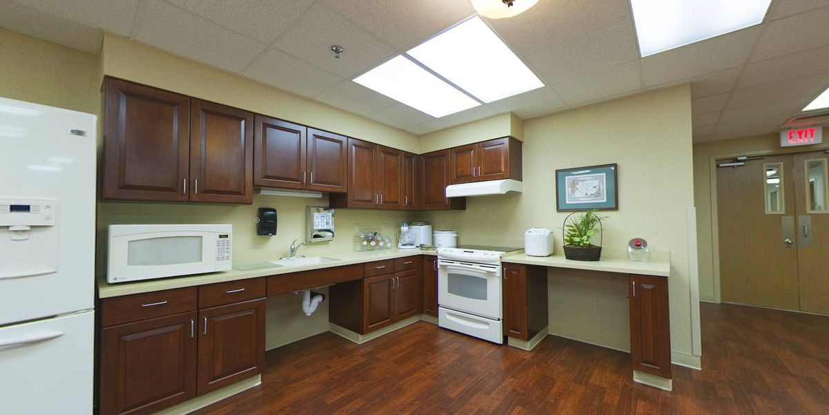 A clean and modern kitchen with wooden cabinets and a white stove.