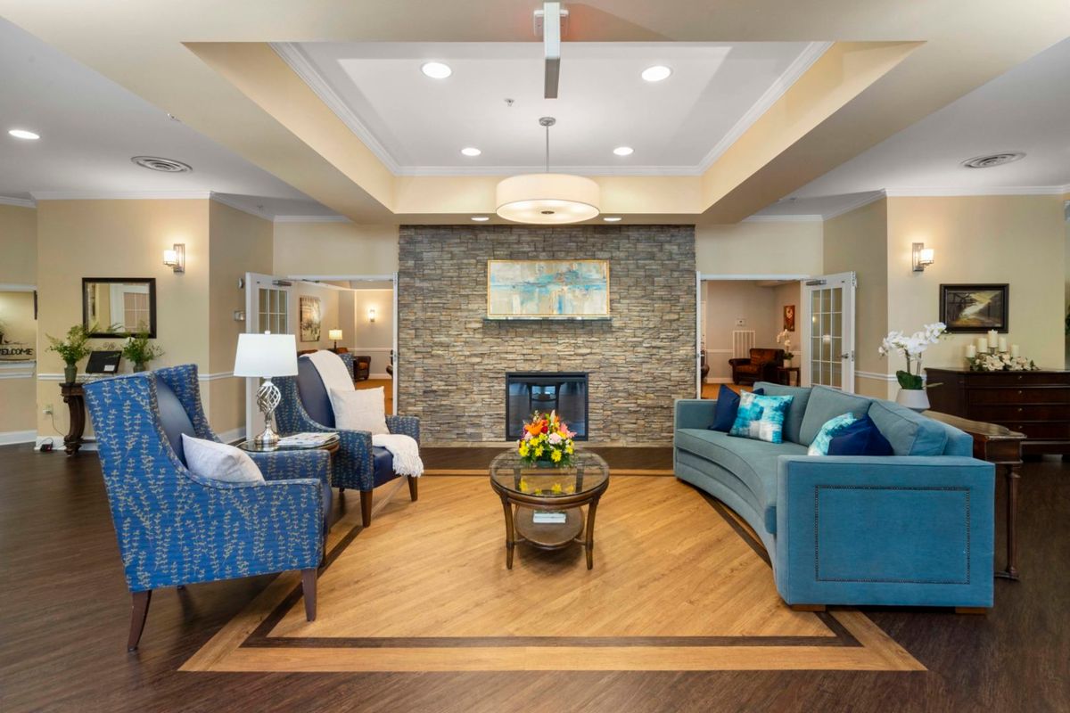 A modern and cozy living room with a central fireplace, elegant furniture, and tasteful decor.