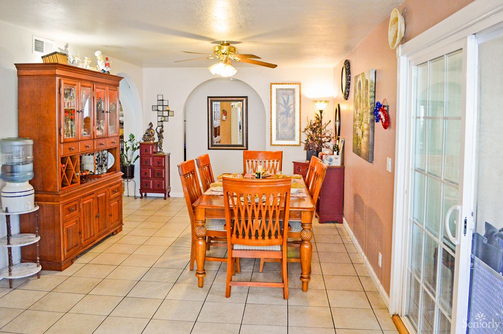 A cozy dining room with wooden furniture and decorative elements.