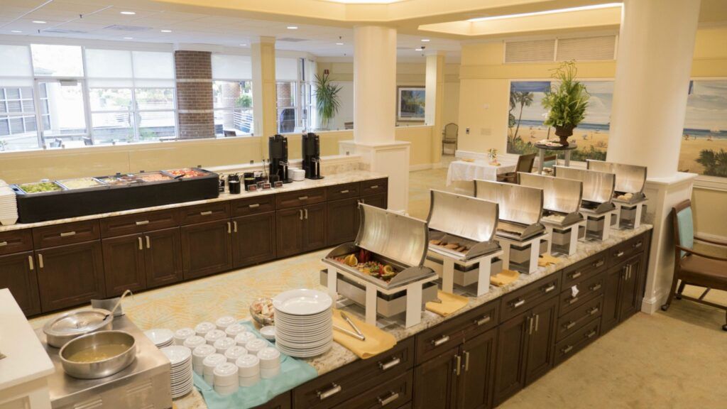 A buffet setup with various serving dishes in a dining area.