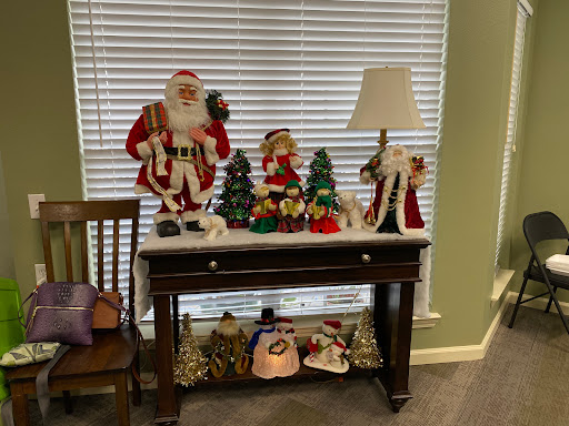 A beautifully arranged holiday display featuring Santa Claus and festive decorations on a table.
