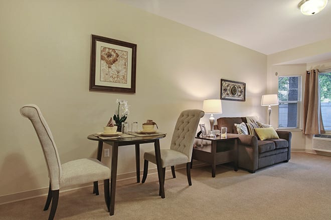 A cozy living and dining area with elegant furniture and warm lighting.