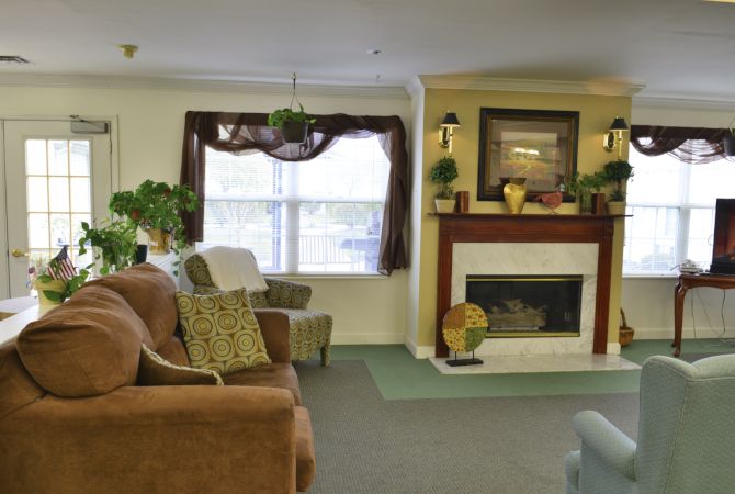A cozy living room with a fireplace and comfortable seating.