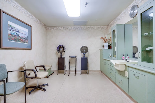 A clean and minimalistic medical waiting area with chairs and equipment.