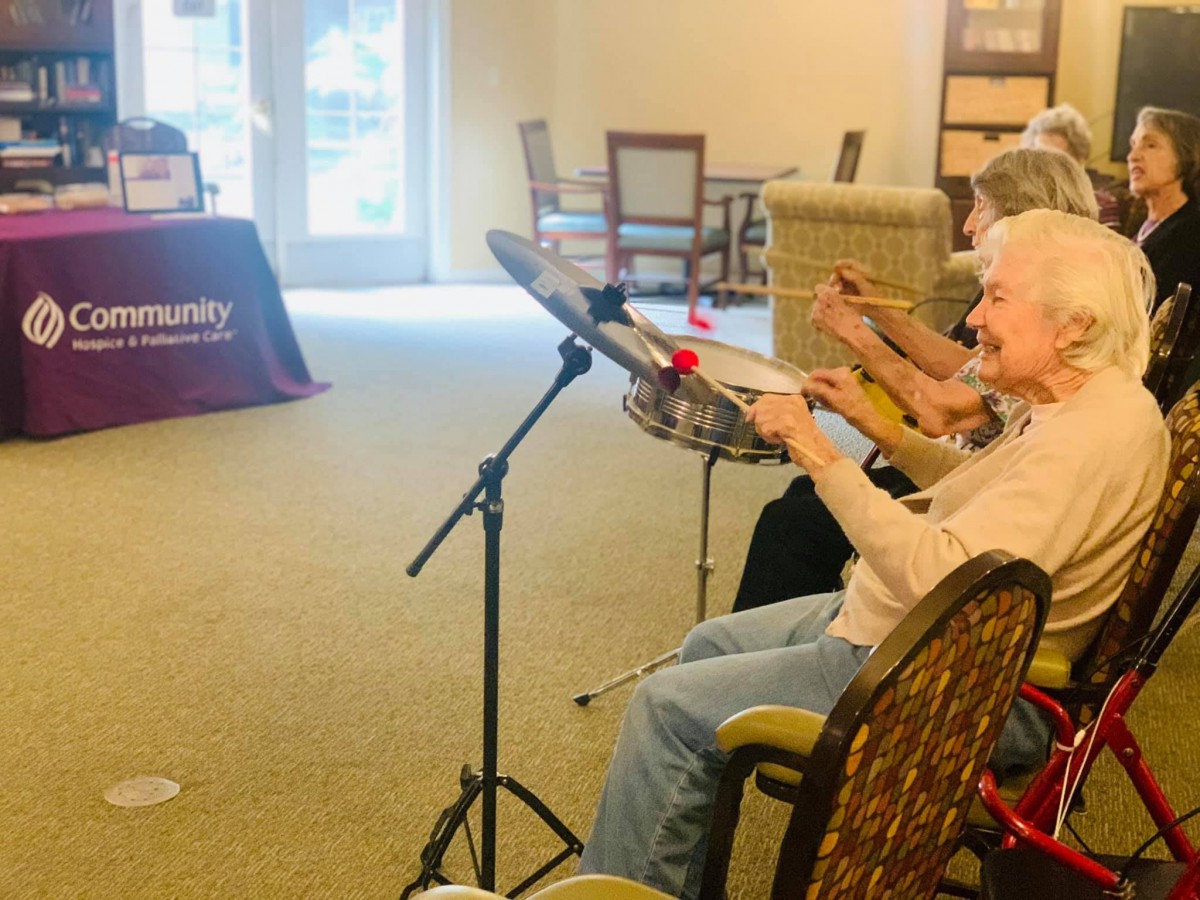 Seniors engaging in a drumming session as part of a community activity.