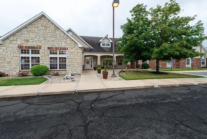 A suburban house with a stone facade and well-maintained landscaping.