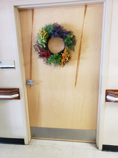 A beautifully decorated door adorned with a colorful wreath, inviting warmth and charm.