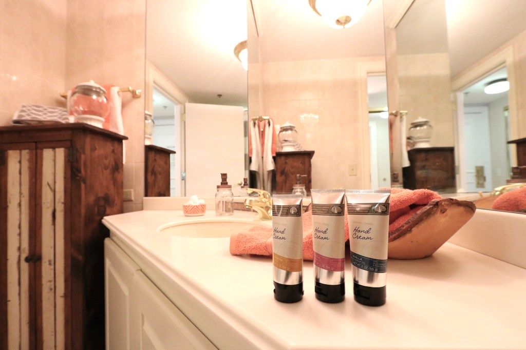 A neatly arranged bathroom countertop with toiletries and towels.