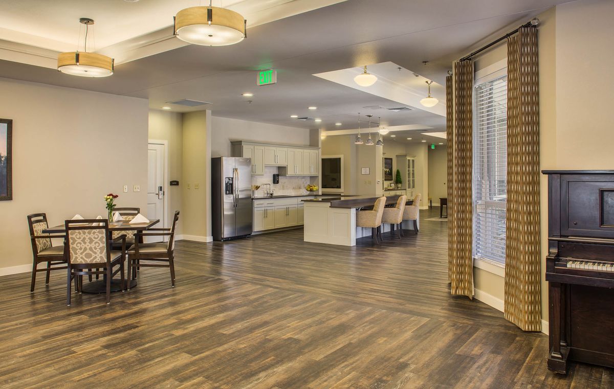 A spacious, modern kitchen and dining area with open design and wooden flooring.