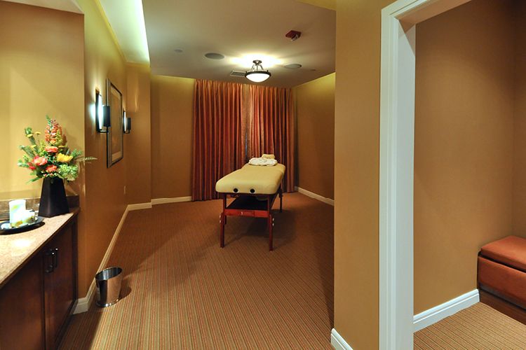 A tranquil massage room with a treatment table ready for use.