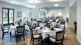 An elegant restaurant dining area with neatly arranged tables and chairs.