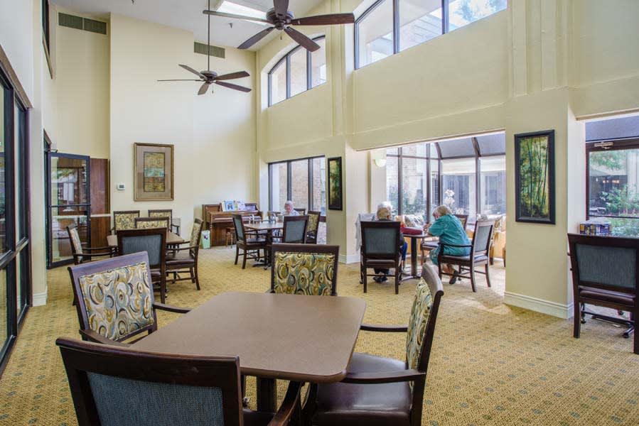 A spacious dining area with large windows allowing natural light to illuminate the room.