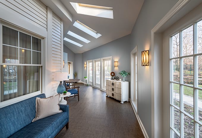 A modern hallway with skylights and elegant decor.