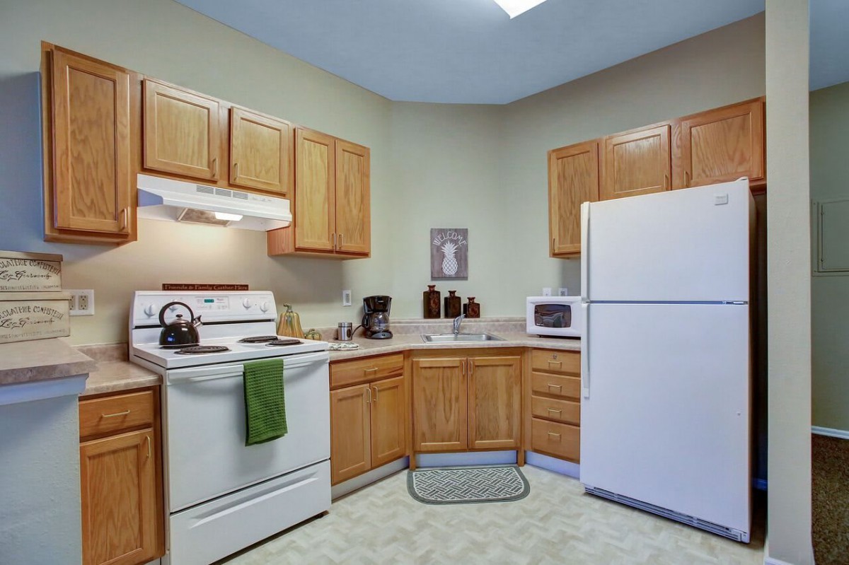 A cozy kitchen with wooden cabinets and modern appliances.