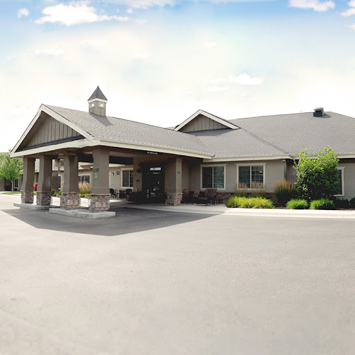 A welcoming entrance of a well-designed building surrounded by greenery.