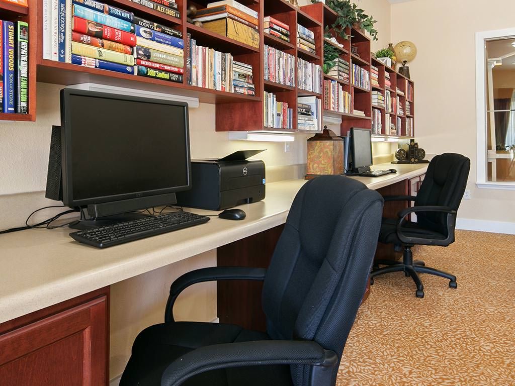 A well-organized office space with computers and bookshelves.