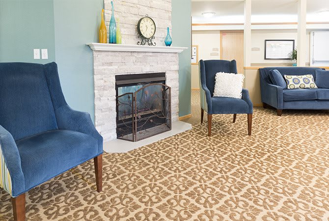 A cozy living room with a stylish fireplace and comfortable armchairs.