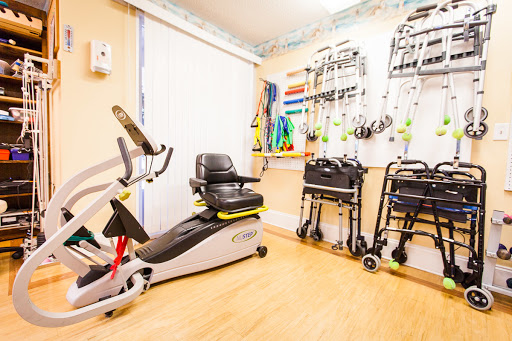 A well-equipped rehabilitation room featuring exercise bikes and mobility aids.