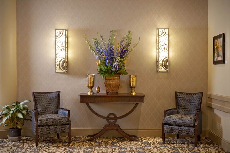 Elegant lobby area with floral arrangement and ambient lighting.
