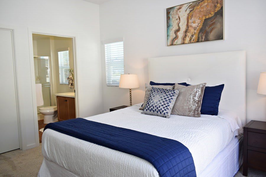 A modern bedroom with blue accents and stylish decor.