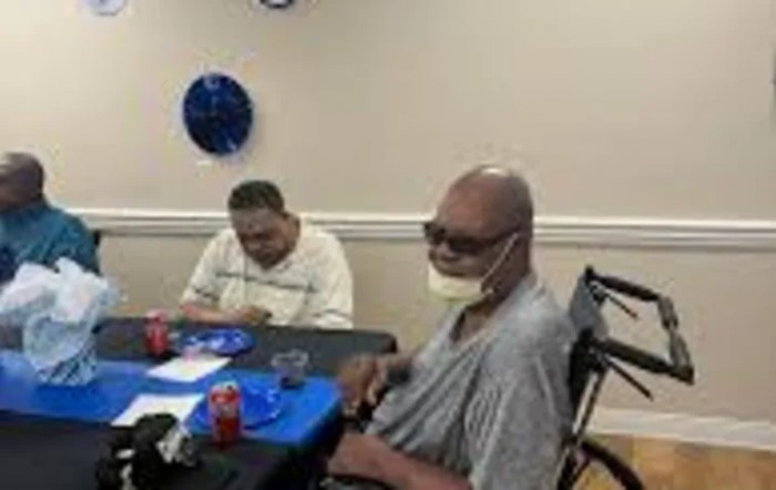 Two people sitting at a table, enjoying a meal during a celebration.
