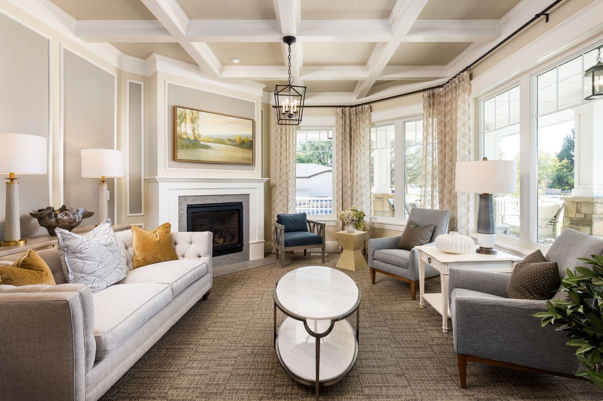 A beautifully decorated living room with elegant furniture and a cozy fireplace.