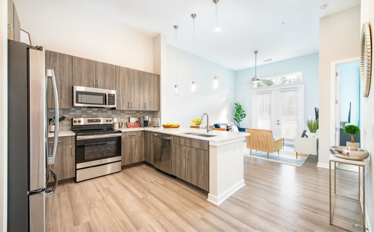 A modern kitchen with stainless steel appliances and sleek interior design.