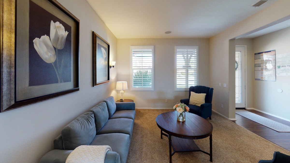A cozy living room with a comfortable sofa, an armchair, and a coffee table.