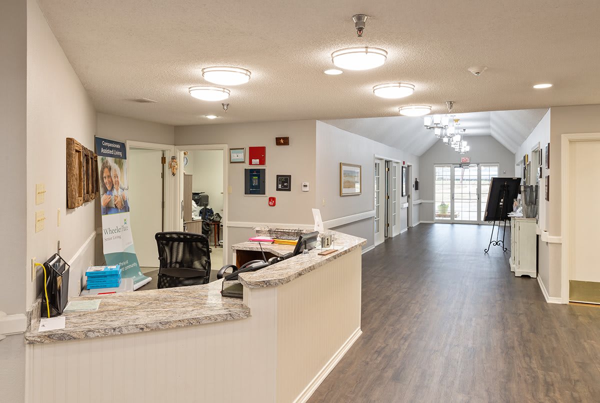 A well-lit office reception area with a welcoming desk and spacious hallway.