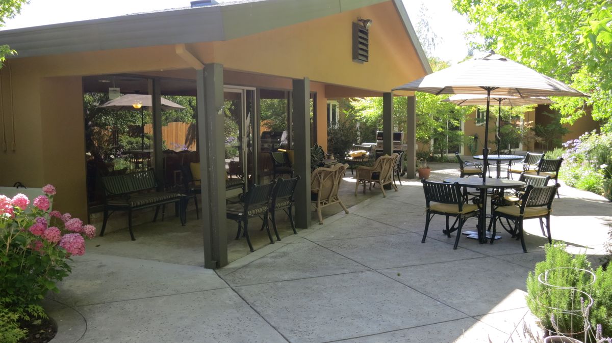 An inviting restaurant patio with outdoor seating under a sunny sky.