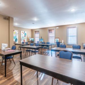 An empty classroom with desks and chairs arranged neatly.