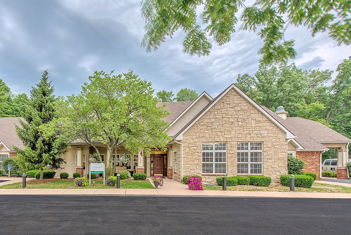 A suburban house with brick exterior and well-maintained landscaping.
