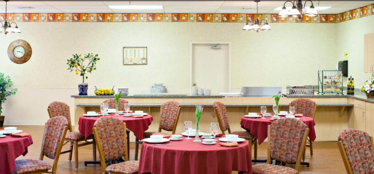 A cozy restaurant dining room with tables set for guests.