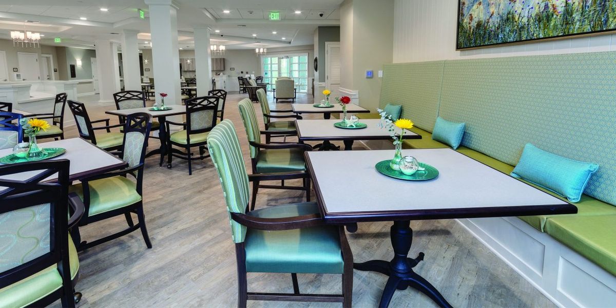 A neatly arranged dining area with tables and chairs.