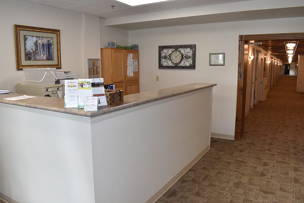 A reception desk area with a counter and office decor.