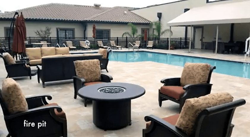 An inviting outdoor patio area featuring a swimming pool, comfortable seating, and a fire pit.