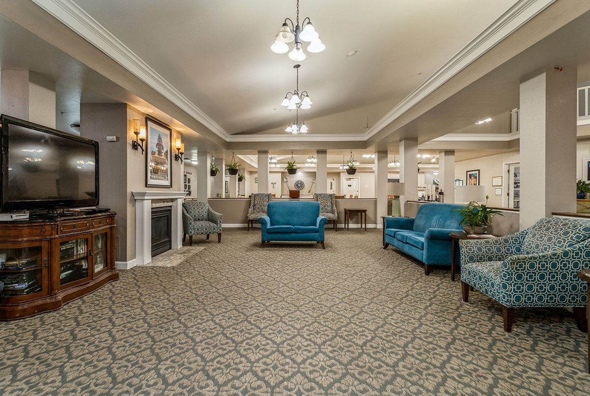 A cozy living room with blue sofas and elegant decor.