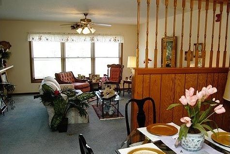 Cozy living room with a dining area, featuring classic furniture and warm decor.