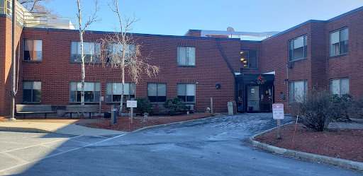 A brick building with a clear sky in the background, indicating winter weather.