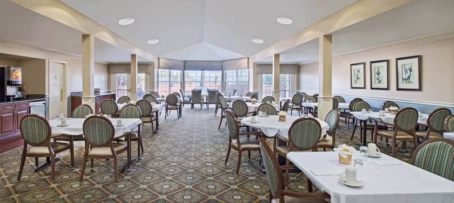 Elegant dining room with neatly arranged tables and chairs.