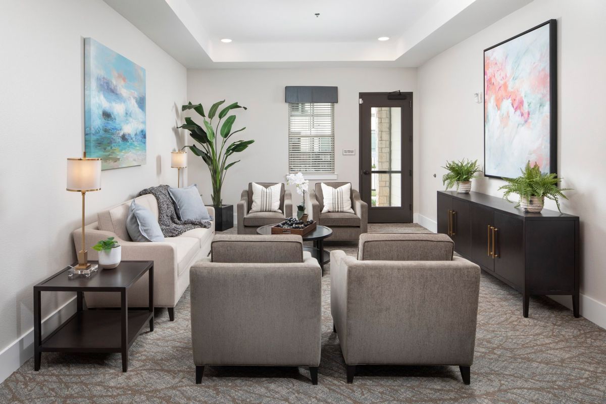 A modern and stylish living room featuring comfortable seating, elegant decor, and contemporary artwork.