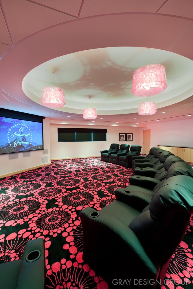 A cozy home theater room with comfortable seating and a large screen for an immersive viewing experience.